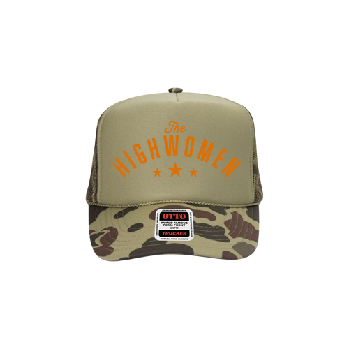 The front of a Green Trucker hat with "The HIGHWOMEN" and a camo colored brim.  